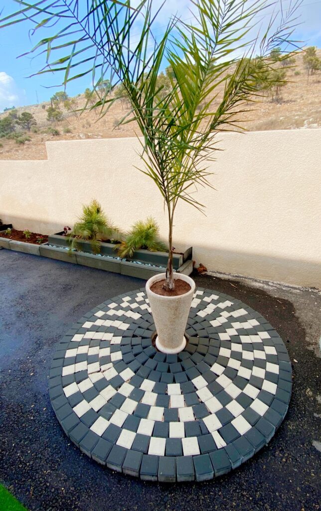 House entrance with a paved retaining-wall garden