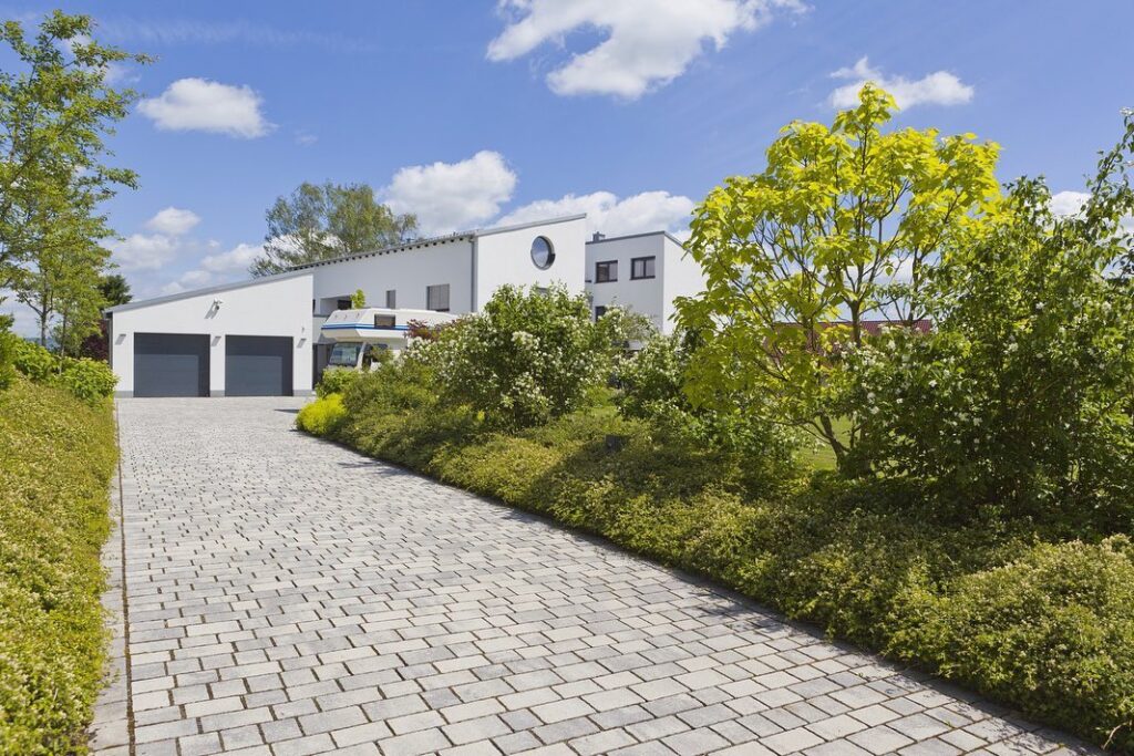Modern white house with a paved driveway